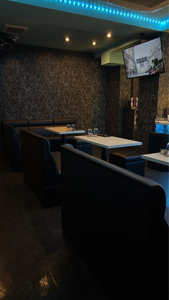 テーブル席とモニターが並ぶ店内